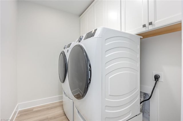 1515 Peabody Ct, Mebane, NC 27302 - laundry room with cabinet space, washer and clothes dryer, and light wood-type flooring