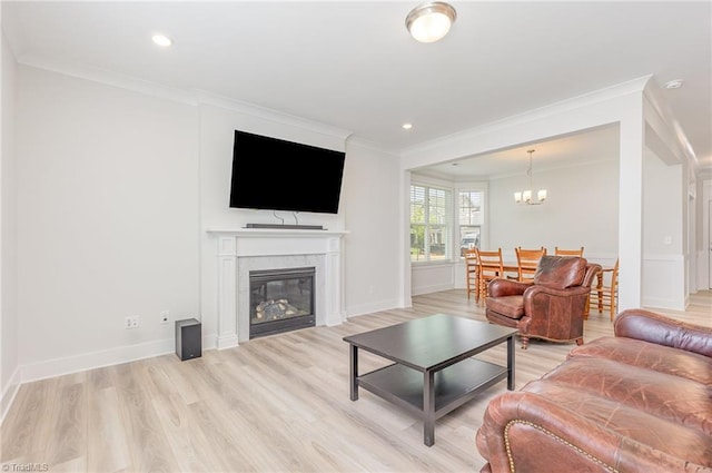 1515 Peabody Ct, Mebane, NC 27302 - living room with a chandelier, ornamental molding, light wood finished floors, a glass covered fireplace, and recessed lighting