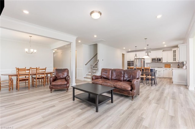 1515 Peabody Ct, Mebane, NC 27302 - living area featuring ornamental molding, light wood finished floors, stairway, recessed lighting, and a chandelier