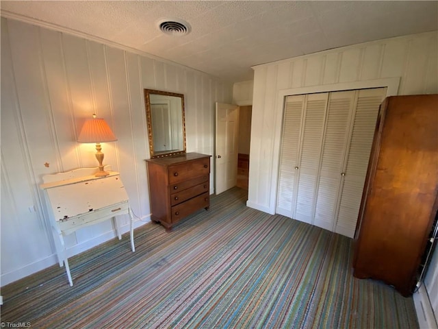 carpeted bedroom with a closet