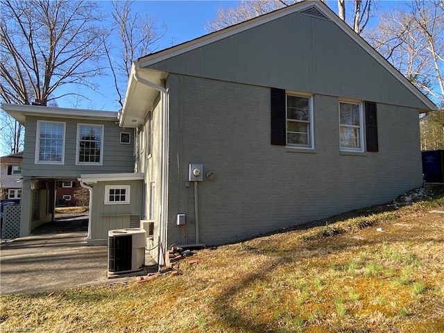 view of home's exterior with a yard and central air condition unit