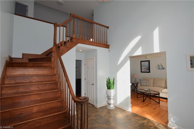 staircase featuring a high ceiling