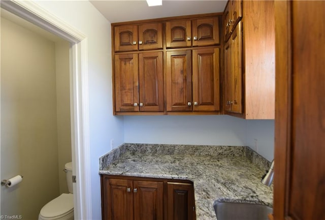 interior space featuring vanity and toilet