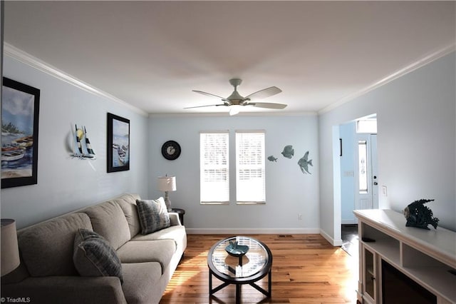 living room with ornamental molding, ceiling fan, and light hardwood / wood-style floors