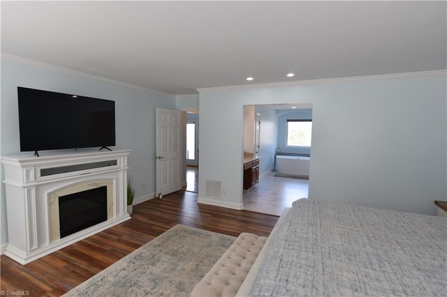 bedroom with dark hardwood / wood-style flooring and crown molding