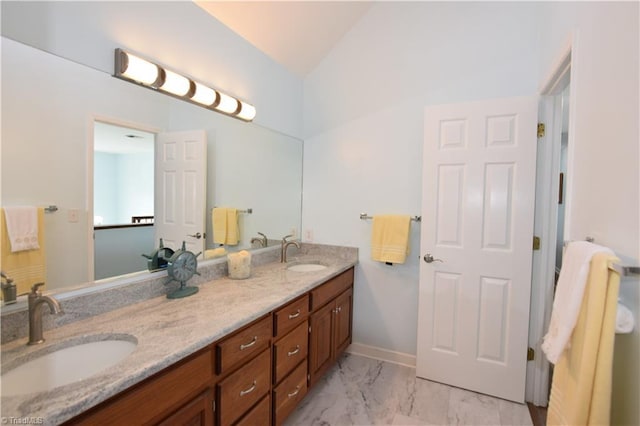 bathroom with vanity and vaulted ceiling