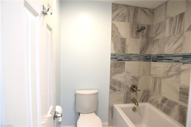 bathroom featuring tiled shower / bath and toilet