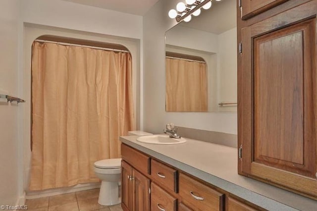 bathroom with tile patterned flooring, vanity, and toilet