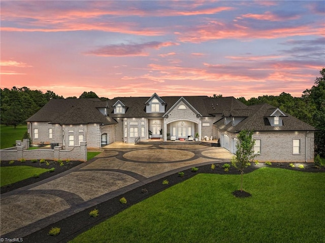 french country style house with a garage and a yard