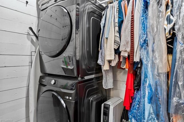 washroom featuring stacked washer / dryer