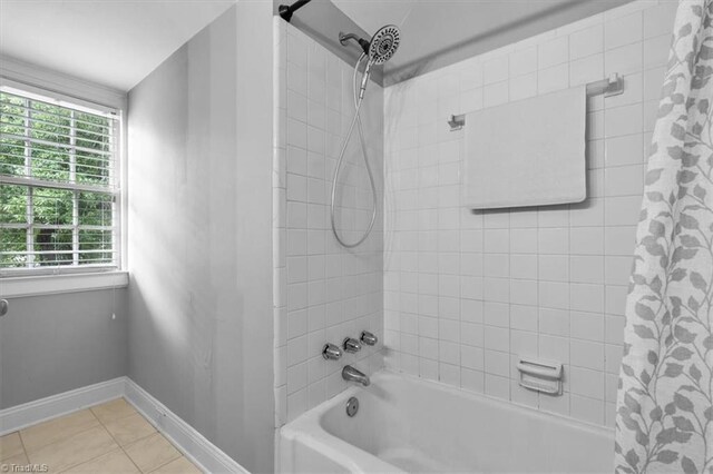 bathroom featuring tile patterned floors, shower / bath combo, and baseboards