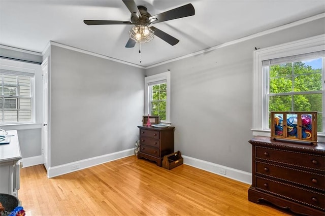 bedroom with baseboards, ornamental molding, light wood-style flooring, and a ceiling fan