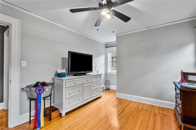 bedroom with ornamental molding, baseboards, light wood-style flooring, and ceiling fan