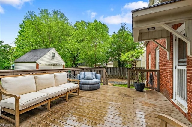 wooden terrace featuring outdoor lounge area and fence