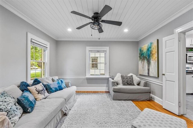 living room featuring wood ceiling, wood finished floors, ornamental molding, a ceiling fan, and recessed lighting