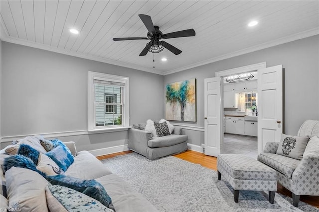 living room with ornamental molding, recessed lighting, wood ceiling, wood finished floors, and a ceiling fan