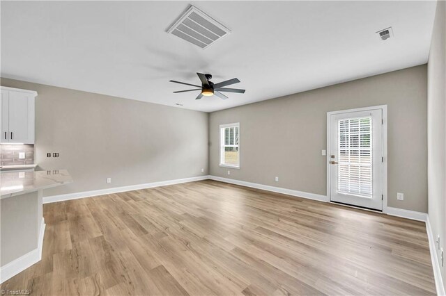 1333 Union Cross Rd, Kernersville, NC 27284 - unfurnished living room with ceiling fan, light wood finished floors, and baseboards