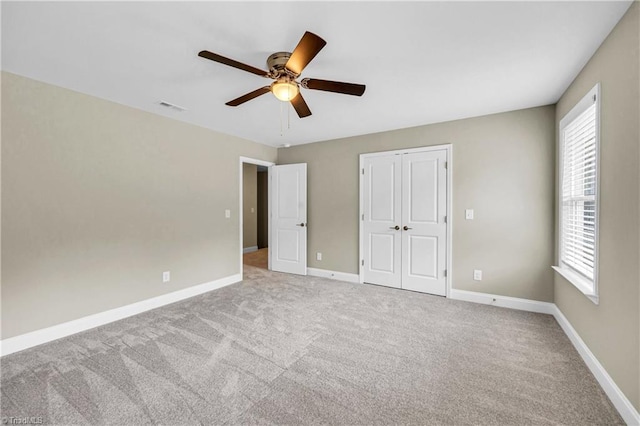 1333 Union Cross Rd, Kernersville, NC 27284 - unfurnished bedroom with multiple windows, carpet flooring, and a ceiling fan