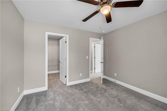 1333 Union Cross Rd, Kernersville, NC 27284 - unfurnished bedroom featuring a walk in closet, carpet, baseboards, a closet, and ceiling fan