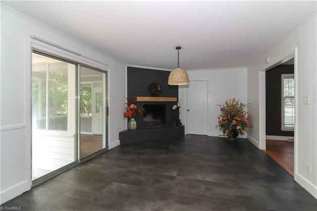 living room featuring crown molding and a brick fireplace