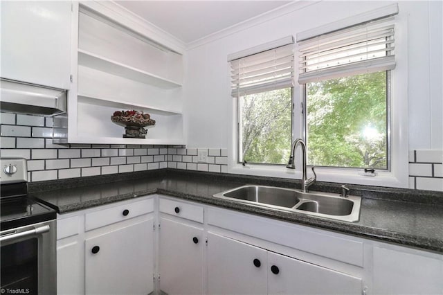 kitchen with a wealth of natural light, sink, stainless steel electric stove, and white cabinetry