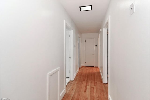 hall with light hardwood / wood-style floors