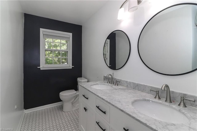 bathroom with tile patterned flooring, vanity, and toilet