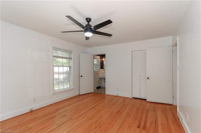 unfurnished bedroom featuring ceiling fan, light hardwood / wood-style floors, and ensuite bath