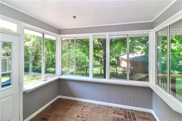 unfurnished sunroom featuring a wealth of natural light