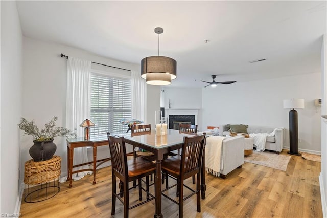221 Quietwood Dr Unit 221, Winston-Salem, NC 27103 - dining space featuring a ceiling fan, light wood-type flooring, and a high end fireplace