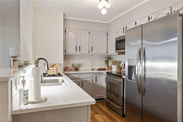 221 Quietwood Dr Unit 221, Winston-Salem, NC 27103 - kitchen featuring stainless steel appliances, light wood-style floors, light countertops, ornamental molding, and backsplash