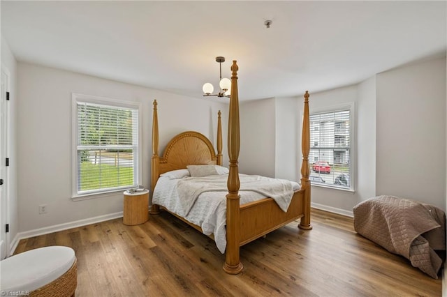 221 Quietwood Dr Unit 221, Winston-Salem, NC 27103 - bedroom featuring multiple windows, wood finished floors, and a chandelier