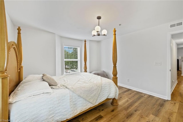 221 Quietwood Dr Unit 221, Winston-Salem, NC 27103 - bedroom featuring a chandelier and wood finished floors