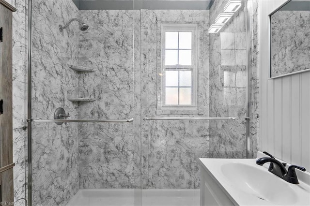 bathroom with a stall shower and vanity