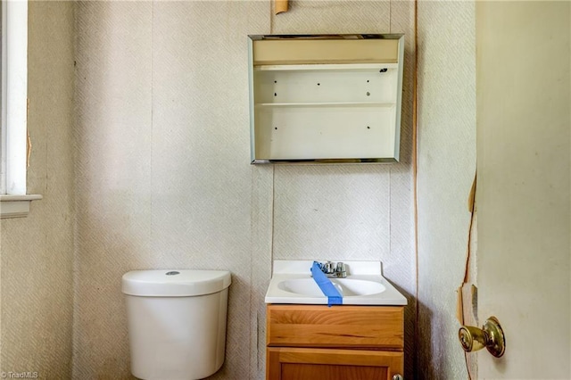 half bath featuring toilet and vanity