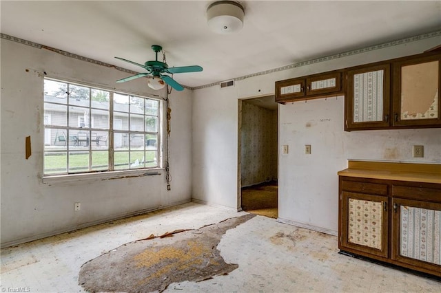 unfurnished room featuring visible vents, baseboards, and a ceiling fan