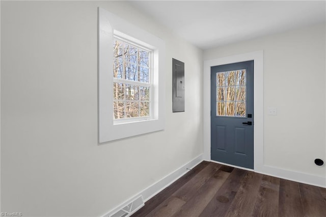 entryway with dark hardwood / wood-style flooring and electric panel