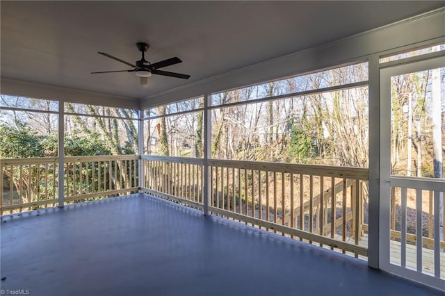 unfurnished sunroom featuring ceiling fan