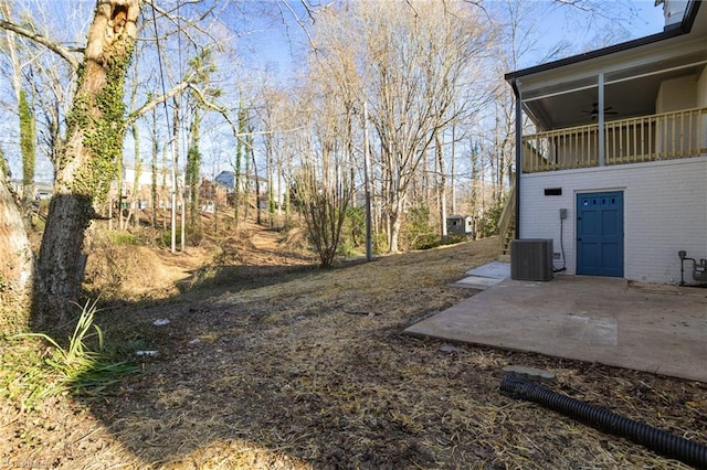 view of yard with ceiling fan, a patio, and central air condition unit