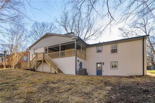 rear view of house with central AC unit and ceiling fan