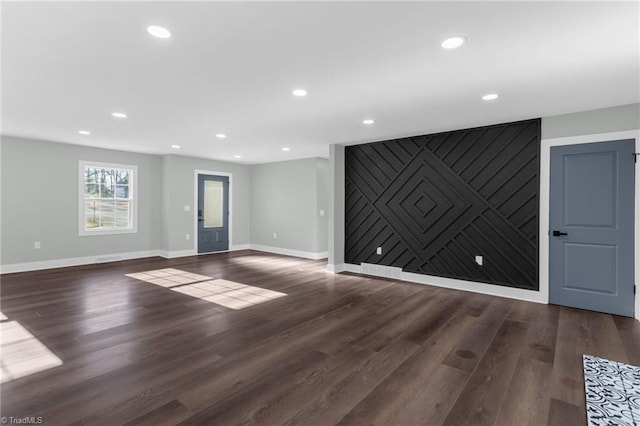 unfurnished living room featuring dark wood-type flooring