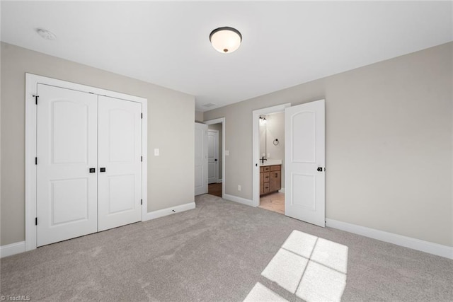 2751 Monarch Way, Winston-Salem, NC 27106 - unfurnished bedroom with light colored carpet, a closet, baseboards, and connected bathroom