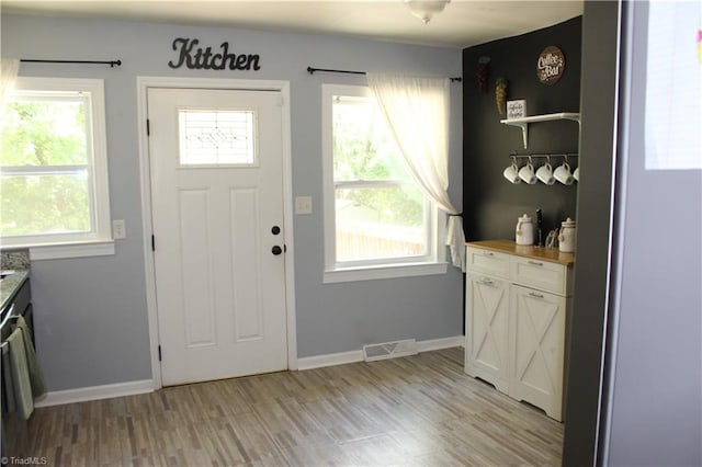 entryway featuring baseboards and visible vents