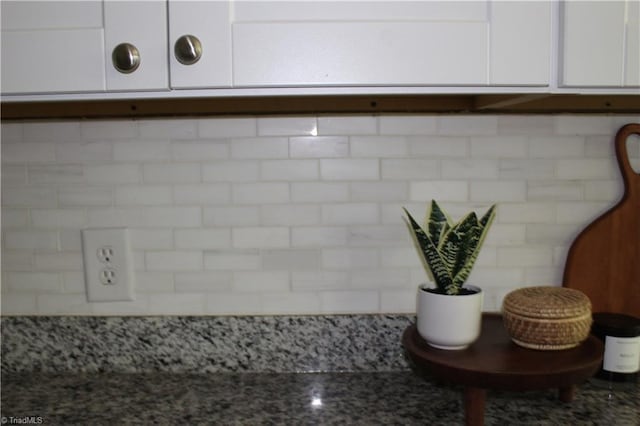 details with white cabinetry and stone counters
