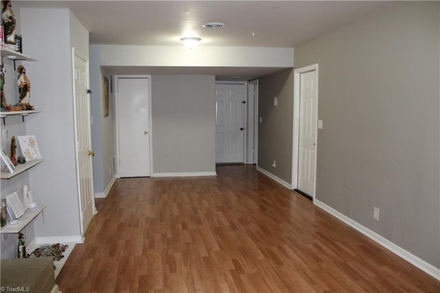 empty room featuring baseboards and wood finished floors