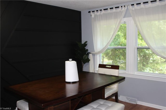 dining area featuring baseboards, visible vents, and wood finished floors