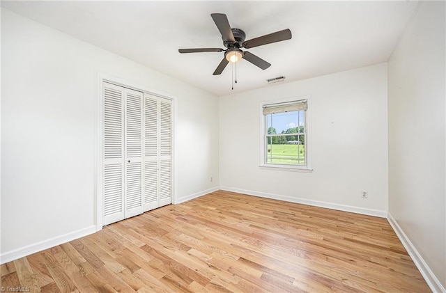 306 Pratt Rd, Dobson, NC 27017 - unfurnished bedroom with light wood-style flooring, a closet, and a ceiling fan