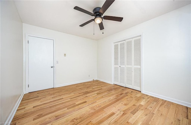 306 Pratt Rd, Dobson, NC 27017 - unfurnished bedroom featuring light wood-style floors, a ceiling fan, and a closet