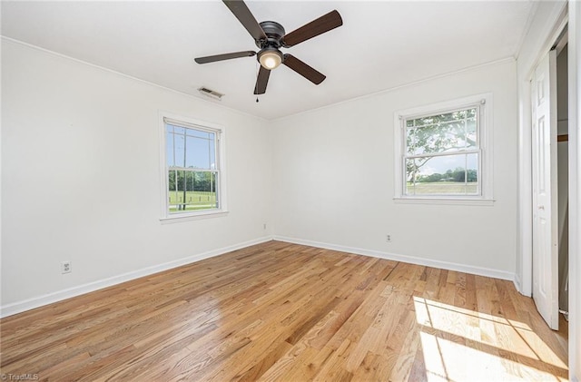 306 Pratt Rd, Dobson, NC 27017 - unfurnished bedroom with multiple windows, ornamental molding, light wood finished floors, and a ceiling fan