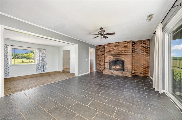 306 Pratt Rd, Dobson, NC 27017 - unfurnished living room featuring a ceiling fan, a fireplace, and ornamental molding